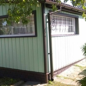 Отделка фасада панелями Doсke S7 Вертикальный Киви и Doсke D4.5 Корабельный брус Банан