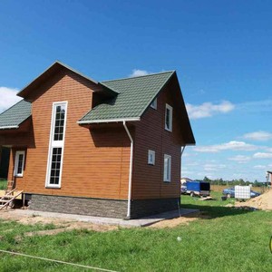 Отделка фасада сайдингом Vox Max 3 дуб золотой 140 м²